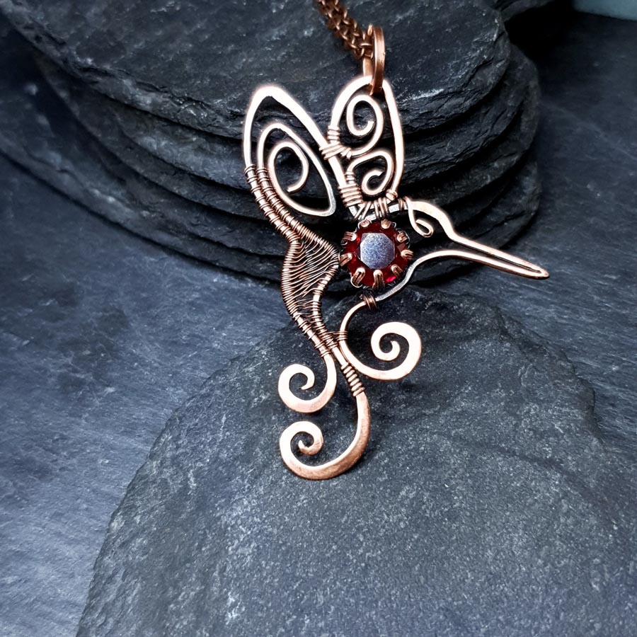 humming bird garnet pendant imbali crafts